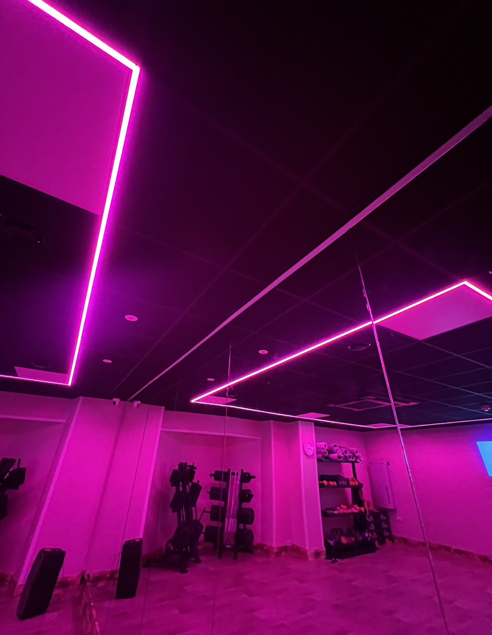 Coloured strip lighting placed in a gym roof